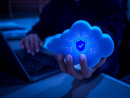 AI-powered cloud computing concept with digital security shield icon in hand. Representing cybersecurity, cloud data protection, artificial intelligence, privacy, and secure technology infrastructure.の写真素材