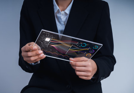Business person in suit analyzing AI data on a futuristic transparent tablet screen with charts and circuit diagrams. Concept of artificial intelligence, data science, and technology innovation.の写真素材