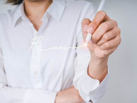 Businesswoman white shirt signing digital document with electronic pen, representing online contract, digital agreement, and e-signature technology for modern business and paperless office solutions.の写真素材