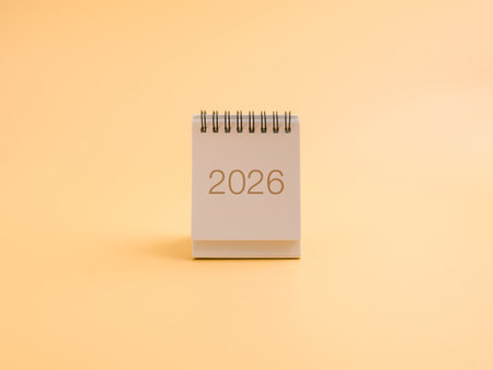 Minimal desk calendar showing year 2026 on soft pastel background. Concept of new year, fresh start, future planning, goal setting, annual resolutions, and time management for upcoming success.の写真素材