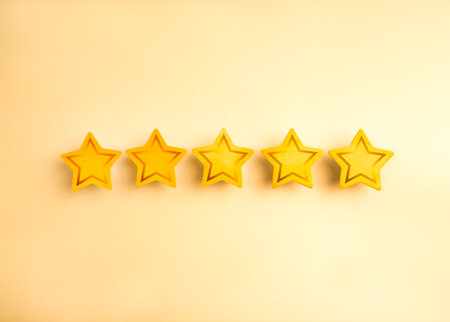 Five yellow stars on yellow background representing excellent rating, customer review, high quality, top performance, user satisfaction, premium service, and business success in digital platforms.の写真素材