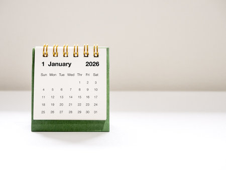 Minimal green desk calendar showing January 2026 page, with clean background and soft lighting. Perfect for business, planning, time management, and new year-related concepts in modern workspace.の写真素材