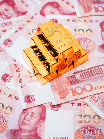 Gold bars stacked on Chinese yuan banknotes background represent wealth, economic growth, and investment in China. Concept of financial stability, currency strength, and global reserve asset strategy.の写真素材
