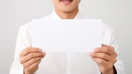 Close up men holding white paper blank for letter paper isolated on white backgroundの素材
