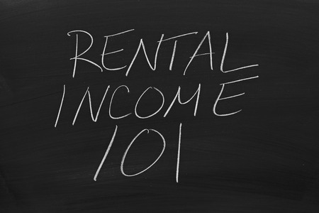 The words "Rental Income 101" on a blackboard in chalkの写真素材