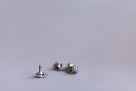 Potentiometers stand on the gray background. Many Potentiometers. Macro close up of electronic...
