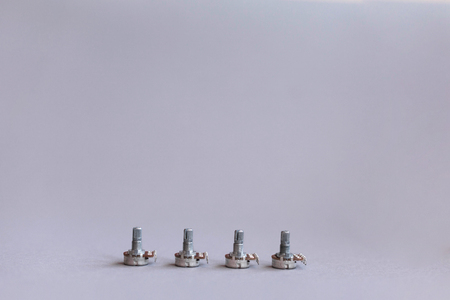 Potentiometers stand on the gray background. Many Potentiometers. Macro close up of electronic component potentiometerの写真素材