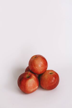 three whole red apple on a white backgroundの写真素材