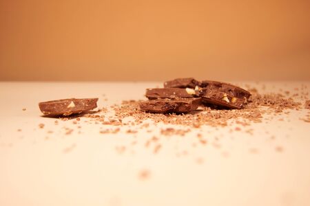 Pieces of chocolate on a background of fine chips. Side viewの写真素材
