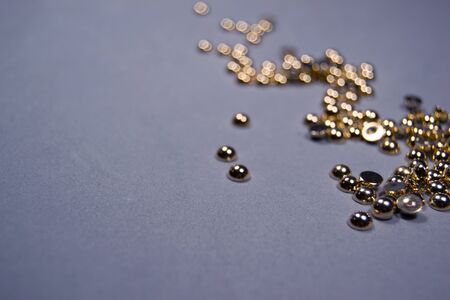 Gold glitter lined with zigzag with blur. Gray background, top view, place for text. Festive minimalismの写真素材