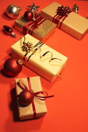 Collection of Christmas gift boxes, Christmas tree red balls and stars for template layout design. The view from the top. Flat lay. Red backgroundの写真素材