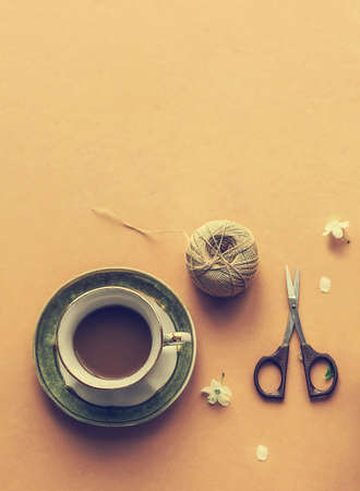 Cup of coffee on a beige background with copy space, top view. Cozy vintage composition. Lifestyle.