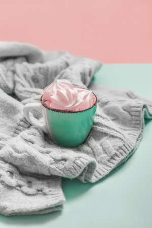 Airy pink marshmallows in a cup on a blue background. Trends color, copy space.の写真素材