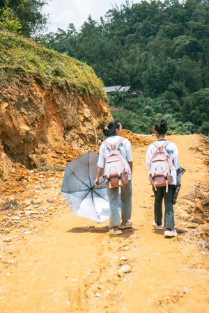 Sa Pa, Vietnam- 05.12.2024. Two girls walking on rural pathの写真素材