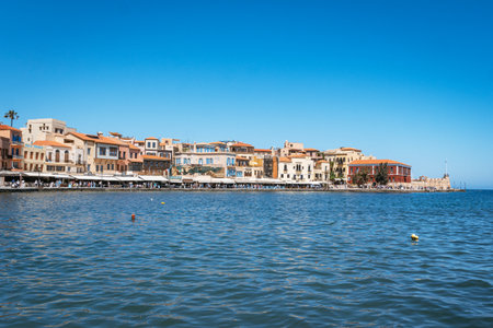 A wide view of the old Venetian Port with its colorful waterfront buildings, a bustling promenade,...