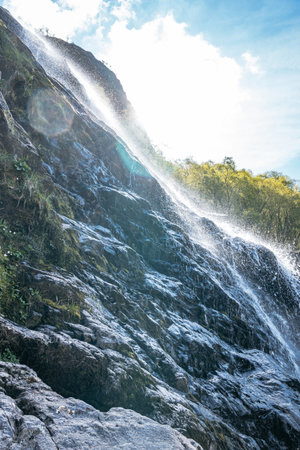 A scenic vertical view of the stunning Steall Falls, Scotland's second highest waterfall, in the...