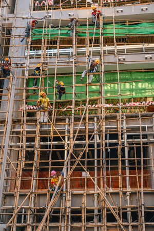 Construction team building high rise structure using traditional bamboo method
