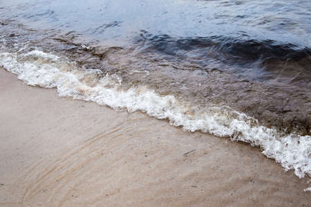 Water wave on the shore of the lake in Karelia. High quality photo