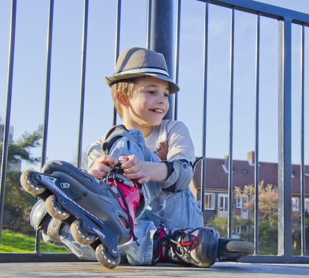 smiling rollerblade   roller skating teenage boy in roller-blading protection kit going skating on inline roller blades  の写真素材