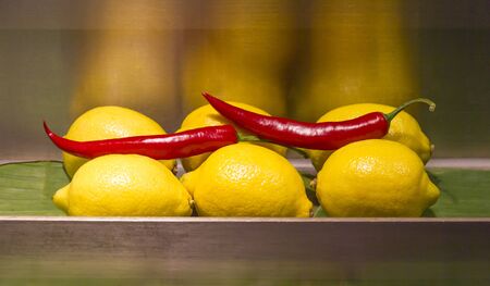 Bright lemons and chili peppersの写真素材