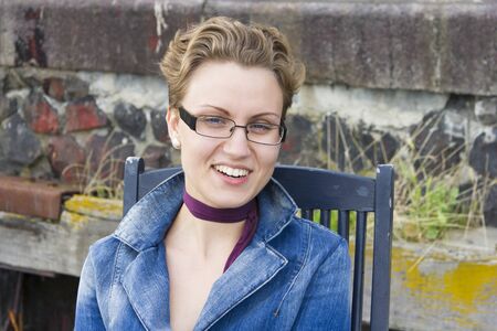 portrait of cute smiling girl in glasses outdoorの写真素材