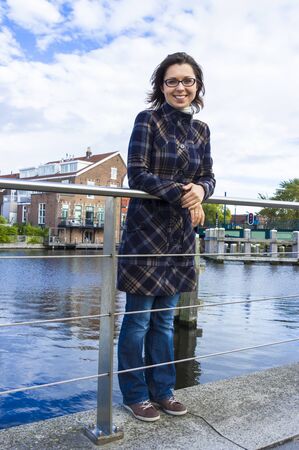 Girl on the waterfront in the Dutch town of Haarlem, the Netherlandsの写真素材