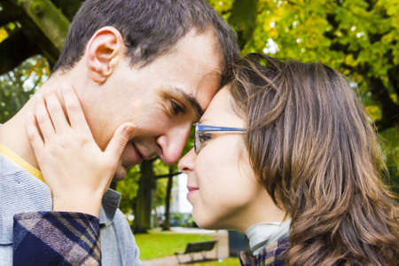 Portrait of love couple embracing outdoor looking happy