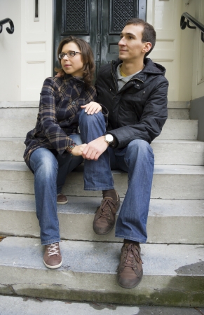 Portrait of love couple sitting on traditional Dutch porch looking happyの写真素材
