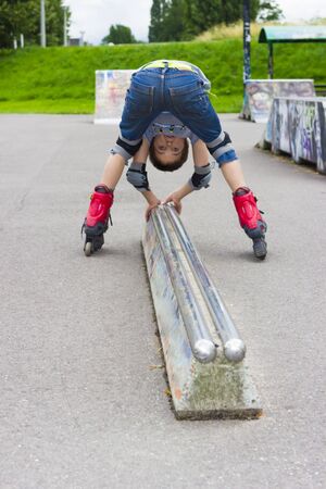 Funny Preschool Aged Rollerskater In Protection Kit Fooling In Playgroundの写真素材