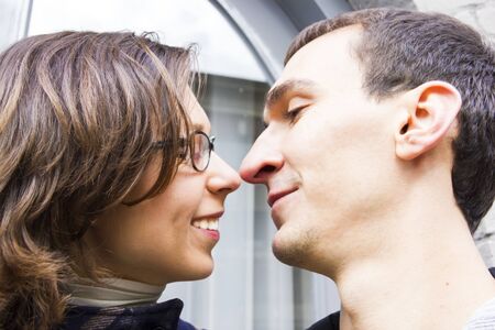 Portrait of love couple embracing outdoor looking happyの写真素材