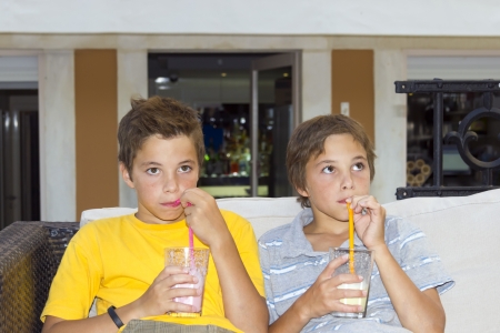 Adorable boys with glasses of milkshakeの写真素材