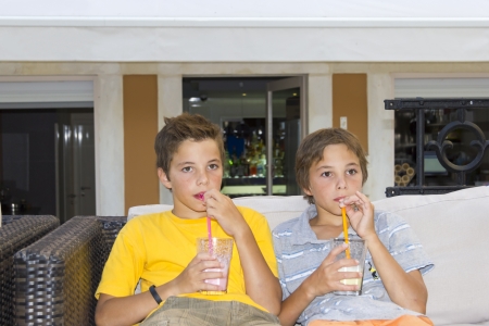 Adorable boys with glasses of milkshakeの写真素材