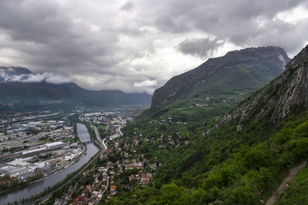 panorama of Grenoble with Alps and deep clouds in backgroundの写真素材