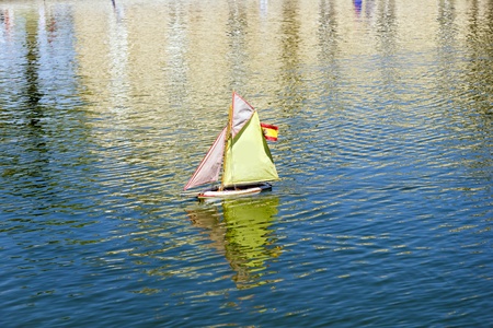 Traditional small wooden sailing boat in the pond of park Jardin du Luxembourg, Paris, Franceの写真素材