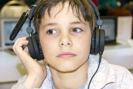 Portrait of a sweet young boy listening to music on headphonesの写真素材