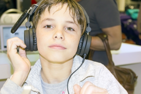 Portrait of a sweet young boy listening to music on headphonesの写真素材