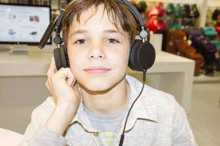 Portrait of a sweet young boy listening to music on headphonesの写真素材
