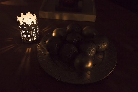 In festive night. Burning candle and Cristmas toysの写真素材