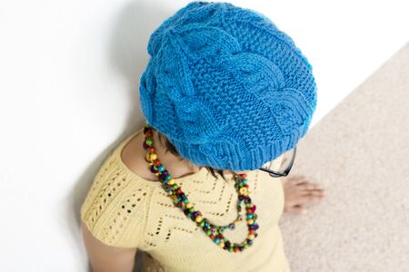 Woman in glasses wearing knitted T-short and hatの写真素材