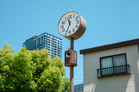 A clock with two birds in the kinder yard of Osaka, Japanの写真素材