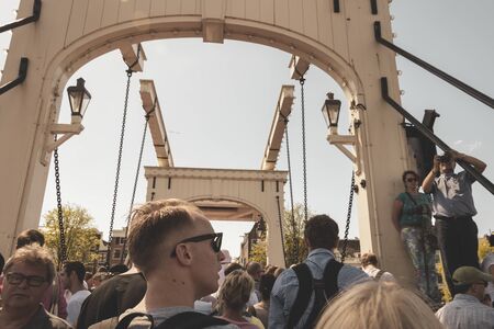 Amsterdam, Netherlands - August 3, 2013: A vintage color tone picture  of Amsterdam gay parade in a canal on a sunny day with people greeting prideのeditorial素材