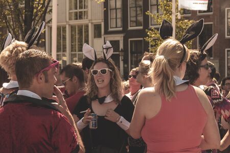 Amsterdam, Netherlands - August 3, 2013: A vintage color tone picture  of Amsterdam gay parade in a canal on a sunny day with people greeting prideのeditorial素材