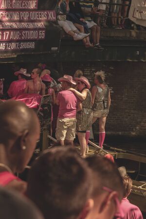 Amsterdam, Netherlands - August 3, 2013: A vintage color tone picture  of Amsterdam gay parade in a canal on a sunny day with people having fun dancing on a boatのeditorial素材