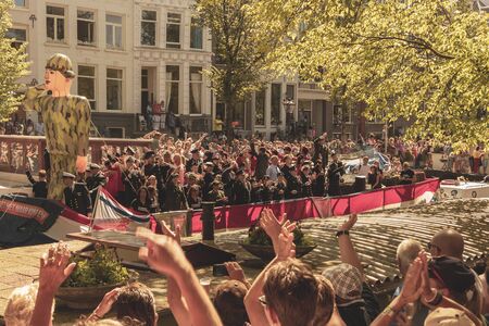 Amsterdam, Netherlands - August 3, 2013: A vintage color tone picture  of Amsterdam gay parade in a canal on a sunny day with people having fun dancing on a boatのeditorial素材