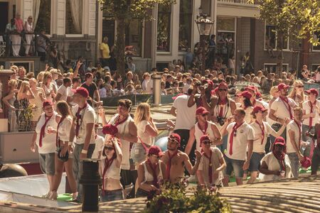 Amsterdam, Netherlands - August 3, 2013: A vintage color tone picture  of Amsterdam gay parade in a canal on a sunny day with people having fun dancing on a boatのeditorial素材
