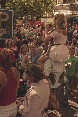 Amsterdam, Netherlands - August 3, 2013: A vintage color tone picture  of Amsterdam gay parade in a canal on a sunny day with people greeting prideのeditorial素材