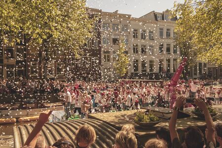 Amsterdam, Netherlands - August 3, 2013: A vintage color tone picture  of Amsterdam gay parade in a canal on a sunny day with people having fun dancing on a boatのeditorial素材