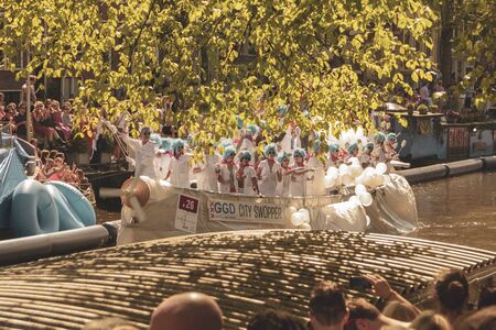 Amsterdam, Netherlands - August 3, 2013: A vintage color tone picture  of Amsterdam gay parade in a canal on a sunny day with people having fun dancing on a boatのeditorial素材