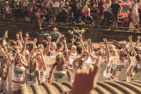 Amsterdam, Netherlands - August 3, 2013: A vintage color tone picture  of Amsterdam gay parade in a canal on a sunny day with people having fun dancing on a boatのeditorial素材