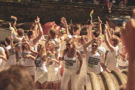 Amsterdam, Netherlands - August 3, 2013: A vintage color tone picture  of Amsterdam gay parade in a canal on a sunny day with people having fun dancing on a boatのeditorial素材